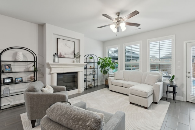 509 Oleander Dr, Royse City, TX 75189 - living room with a ceiling fan, a glass covered fireplace, wood finished floors, and baseboards