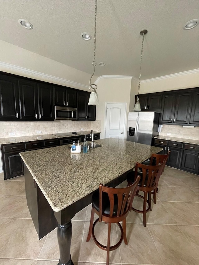 340 Prince John Dr, Saginaw, TX 76179 - kitchen with appliances with stainless steel finishes, crown molding, dark cabinetry, backsplash, and stone countertops