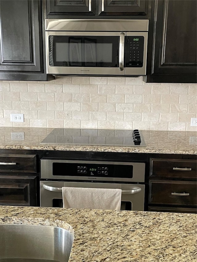 340 Prince John Dr, Saginaw, TX 76179 - kitchen featuring appliances with stainless steel finishes, a sink, backsplash, and light stone countertops
