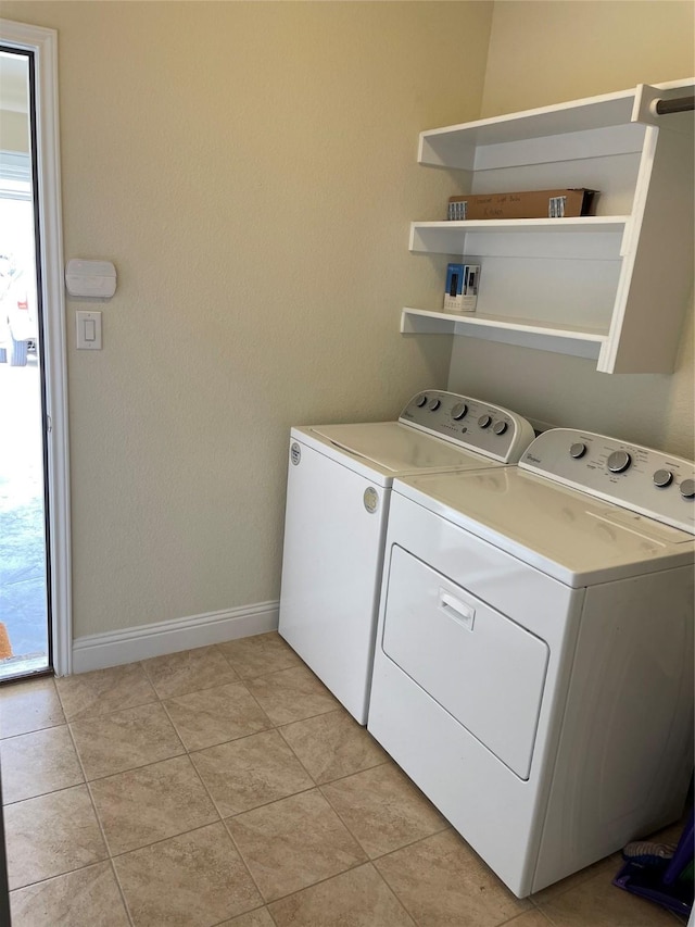 340 Prince John Dr, Saginaw, TX 76179 - laundry room featuring separate washer and dryer, baseboards, and light tile patterned flooring