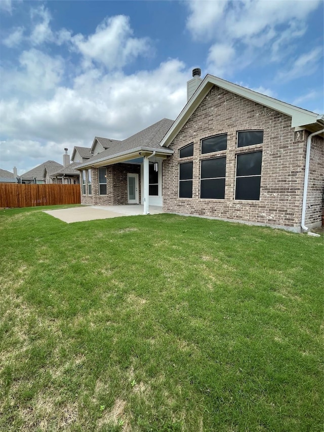 340 Prince John Dr, Saginaw, TX 76179 - back of property with brick siding, a patio, and a chimney