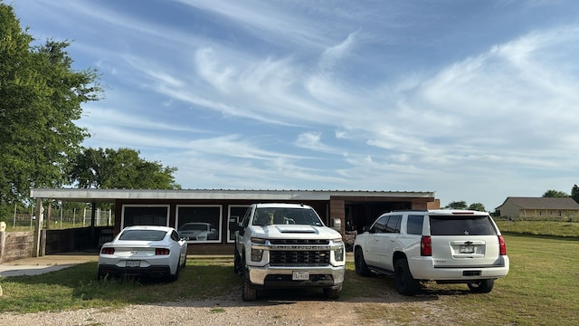 view of parking / parking lot featuring an attached carport