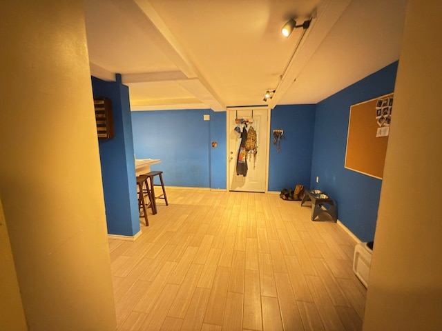 cinema room featuring wood finished floors and baseboards