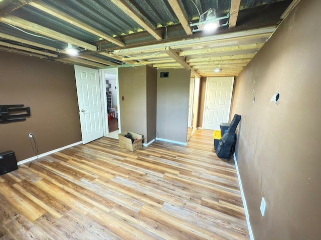 empty room featuring wood finished floors and baseboards