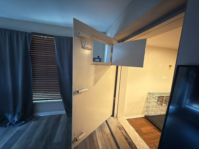 bathroom featuring wood finished floors and baseboards