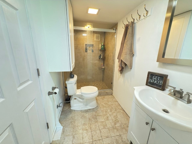 full bathroom with toilet, a shower stall, vanity, baseboards, and tile patterned flooring