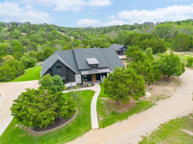 1014 Eagles Ridge Ct, Weatherford, TX 76087 - view of front of home featuring a standing seam roof, covered porch, metal roof, and a wooded view