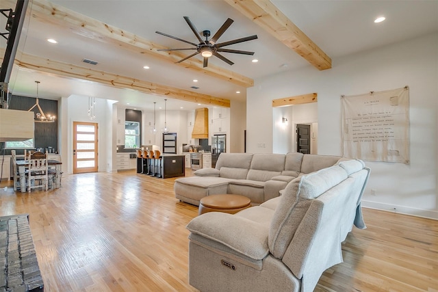 1014 Eagles Ridge Ct, Weatherford, TX 76087 - living area with beam ceiling, light wood-style flooring, ceiling fan, recessed lighting, and a chandelier