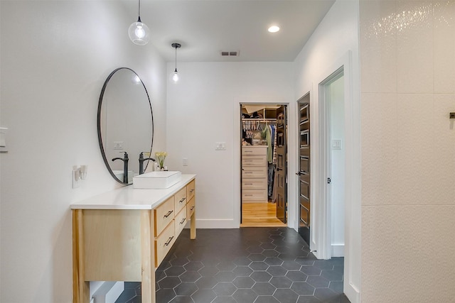 1014 Eagles Ridge Ct, Weatherford, TX 76087 - bathroom with vanity, tile patterned floors, a walk in closet, and recessed lighting
