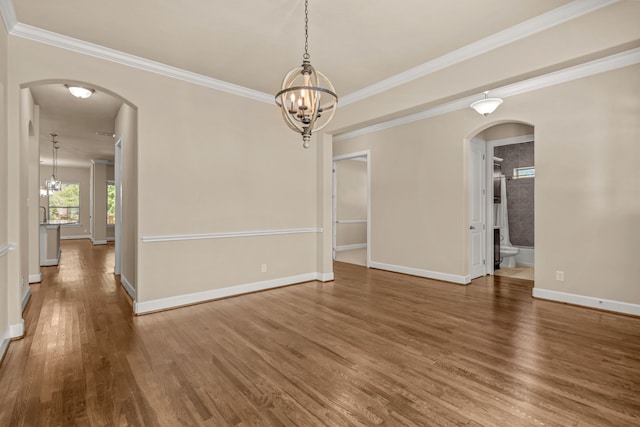 508 Hidden Meadow Dr, Keller, TX 76248 - spare room featuring arched walkways, wood finished floors, a chandelier, ornamental molding, and baseboards