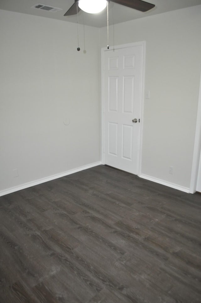 412 Poplar St, Italy, TX 76651 - spare room featuring ceiling fan, dark wood-style floors, and baseboards