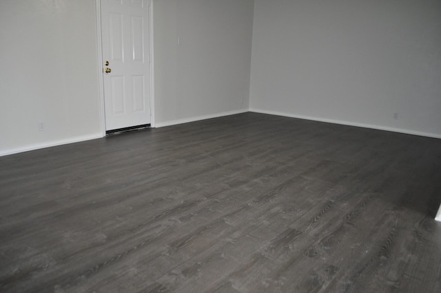 412 Poplar St, Italy, TX 76651 - empty room with dark wood finished floors and baseboards
