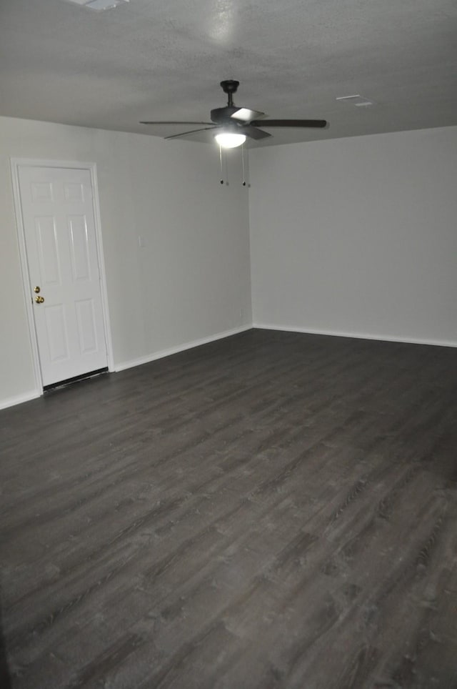 412 Poplar St, Italy, TX 76651 - empty room with a ceiling fan, dark wood finished floors, and baseboards