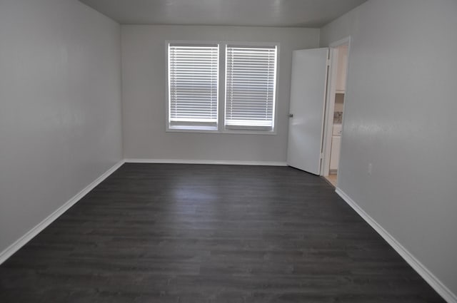 412 Poplar St, Italy, TX 76651 - spare room with dark wood-style flooring and baseboards