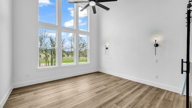 ZEPHYR2TBD Eagles Ridge Dr, Brock, TX 76087 - empty room with ceiling fan, baseboards, light wood-type flooring, and a towering ceiling