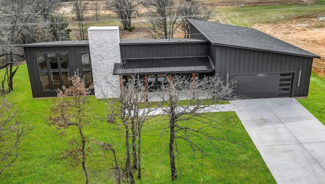 ZEPHYR2TBD Eagles Ridge Dr, Brock, TX 76087 - view of front facade with board and batten siding, concrete driveway, a front yard, a chimney, and an attached garage