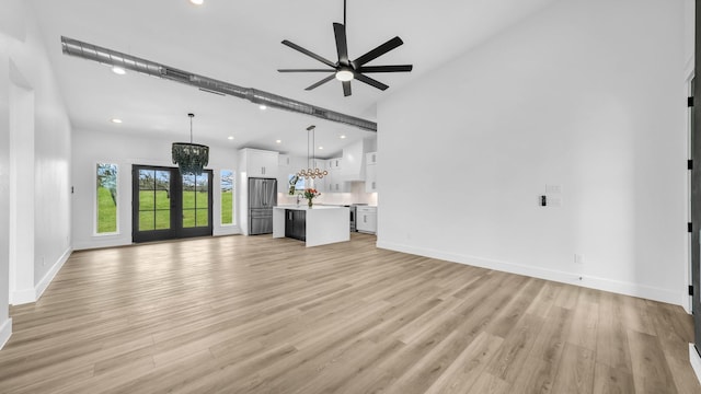 ZEPHYR2TBD Eagles Ridge Dr, Brock, TX 76087 - unfurnished living room featuring a chandelier, ceiling fan, light wood-type flooring, recessed lighting, and baseboards