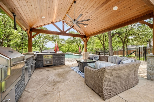 7313 Jo Will St, Colleyville, TX 76034 - fenced backyard with wine cooler, ceiling fan, a gazebo, an outdoor living space, and a patio area