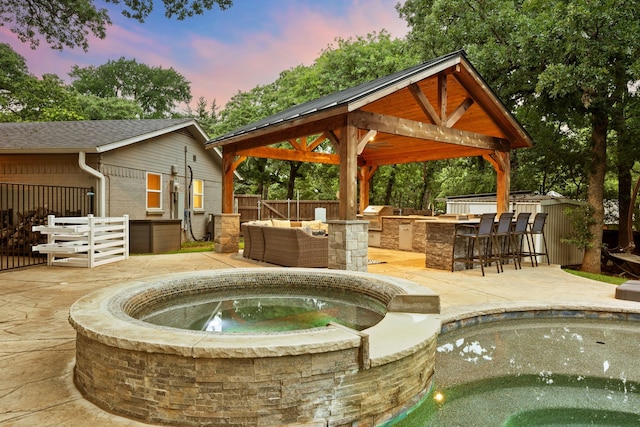 7313 Jo Will St, Colleyville, TX 76034 - pool at dusk with an in-ground hot tub, a patio area, and a gazebo