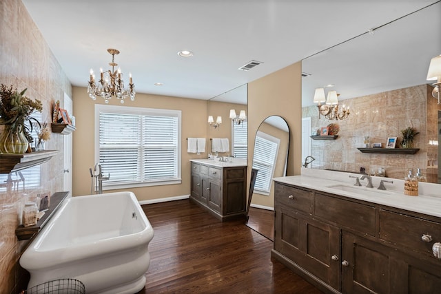 4233 Pershing Ave, Fort Worth, TX 76107 - full bathroom featuring a chandelier, wood finished floors, two vanities, and recessed lighting