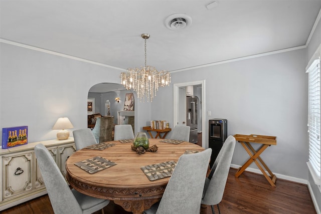 4233 Pershing Ave, Fort Worth, TX 76107 - dining space featuring arched walkways, ornamental molding, a chandelier, dark wood-style flooring, and baseboards