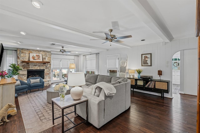 4233 Pershing Ave, Fort Worth, TX 76107 - living area featuring arched walkways, beamed ceiling, a ceiling fan, and plenty of natural light
