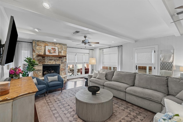 4233 Pershing Ave, Fort Worth, TX 76107 - living room with a ceiling fan, beam ceiling, light wood-style flooring, a stone fireplace, and recessed lighting