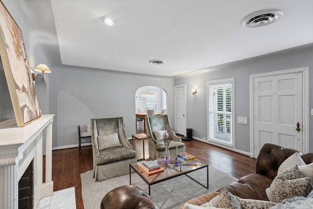 4233 Pershing Ave, Fort Worth, TX 76107 - living area with arched walkways, baseboards, and wood finished floors