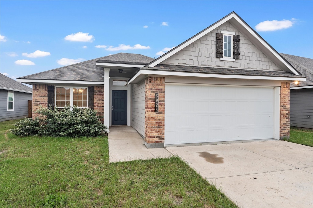 3925 Centerfire Rd, Waco, TX 76705 - view of front of home featuring brick siding, concrete driveway, a shingled roof, and a front yard