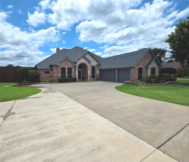 104 Olives Br, Shady Shores, TX 76208 - french provincial home with a garage, curved driveway, a front yard, brick siding, and a chimney