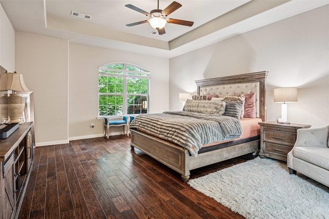 11589 Geranium Dr, Frisco, TX 75035 - bedroom with dark wood finished floors, a raised ceiling, baseboards, and a ceiling fan