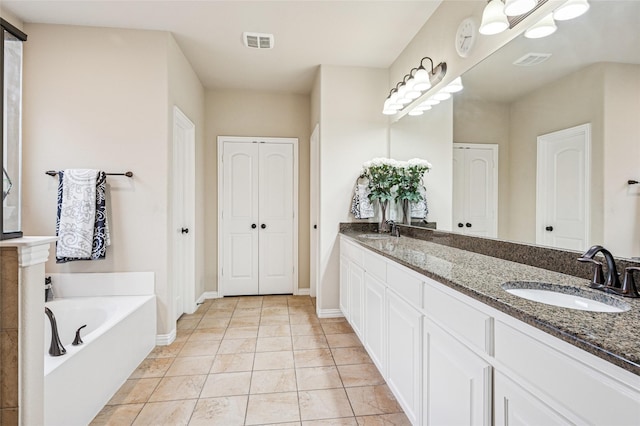 11589 Geranium Dr, Frisco, TX 75035 - full bath featuring a garden tub, double vanity, a closet, and baseboards