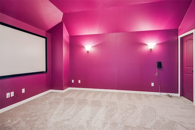 11589 Geranium Dr, Frisco, TX 75035 - carpeted home theater room featuring vaulted ceiling and baseboards