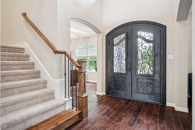 11589 Geranium Dr, Frisco, TX 75035 - foyer featuring wood finished floors, arched walkways, baseboards, stairway, and french doors