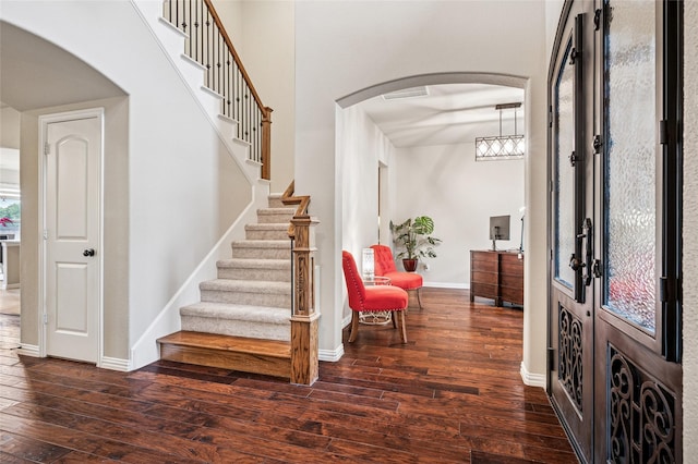 11589 Geranium Dr, Frisco, TX 75035 - entryway with arched walkways, hardwood / wood-style floors, stairs, and baseboards