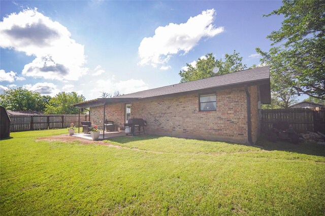 304 Moore St, Jacksboro, TX 76458 - back of house featuring brick siding and a patio