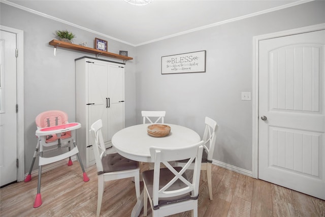 304 Moore St, Jacksboro, TX 76458 - dining space featuring light wood-type flooring, ornamental molding, and baseboards