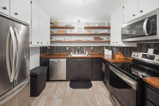304 Moore St, Jacksboro, TX 76458 - kitchen featuring stainless steel appliances, a sink, open shelves, and white cabinetry