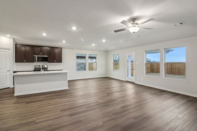 968 Linden Ct, Lavon, TX 75166 - unfurnished living room with dark wood-type flooring, recessed lighting, baseboards, ceiling fan, and a sink