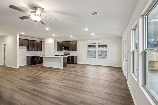 968 Linden Ct, Lavon, TX 75166 - kitchen with stainless steel appliances, open floor plan, baseboards, dark brown cabinetry, and an island with sink