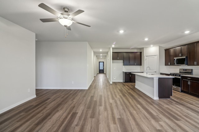 968 Linden Ct, Lavon, TX 75166 - kitchen featuring stainless steel appliances, wood finished floors, a sink, light countertops, and dark brown cabinetry
