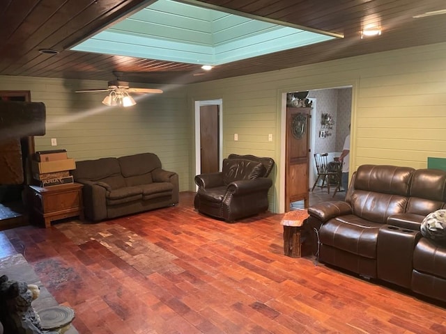 909 Mckinney Ave, Princeton, TX 75407 - living room featuring wood finished floors, a ceiling fan, wooden walls, and wood ceiling