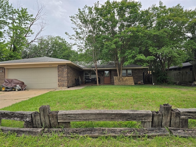 909 Mckinney Ave, Princeton, TX 75407 - view of front of house with a garage, brick siding, a front lawn, and concrete driveway
