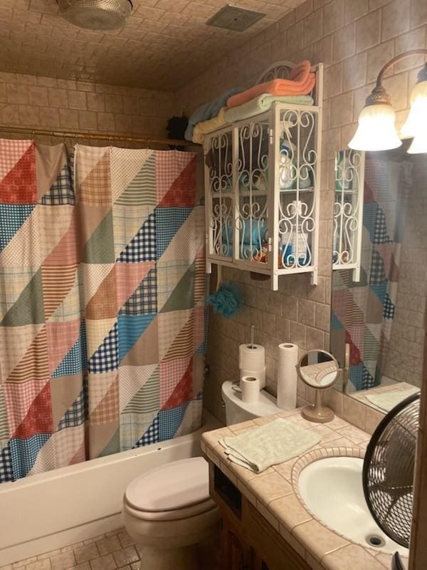 909 Mckinney Ave, Princeton, TX 75407 - bathroom with shower / tub combo, vanity, and toilet