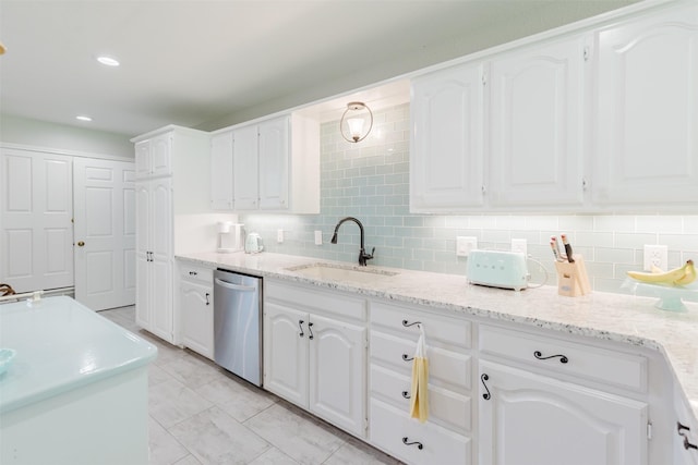 305 Brookview Dr, Decatur, TX 76234 - kitchen with stainless steel dishwasher, a sink, white cabinetry, decorative backsplash, and recessed lighting