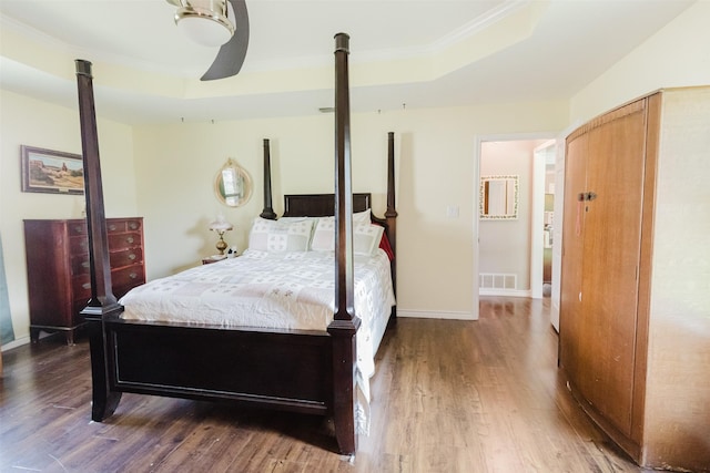 305 Brookview Dr, Decatur, TX 76234 - bedroom with wood finished floors, crown molding, a raised ceiling, baseboards, and a ceiling fan