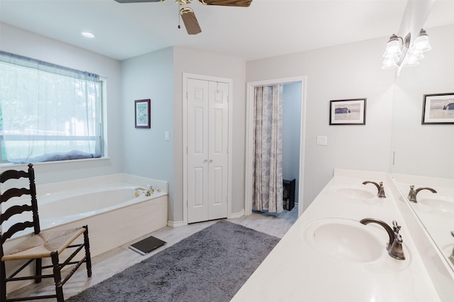 305 Brookview Dr, Decatur, TX 76234 - bathroom with a ceiling fan, a bath, double vanity, and a closet
