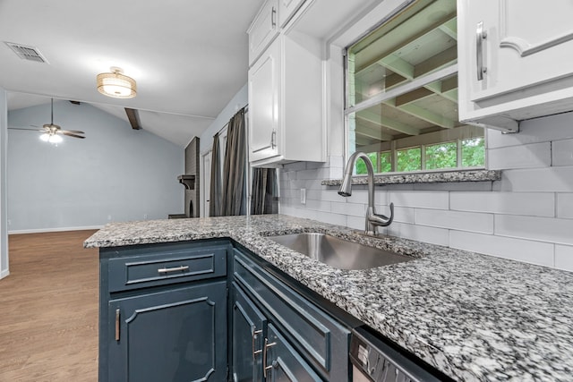 5225 Fallworth Ct, Fort Worth, TX 76133 - kitchen with a sink, white cabinets, backsplash, a peninsula, and vaulted ceiling