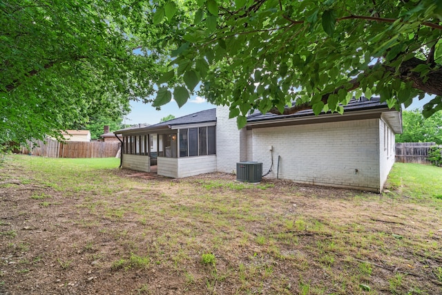 5225 Fallworth Ct, Fort Worth, TX 76133 - rear view of property with a sunroom, brick siding, and central AC