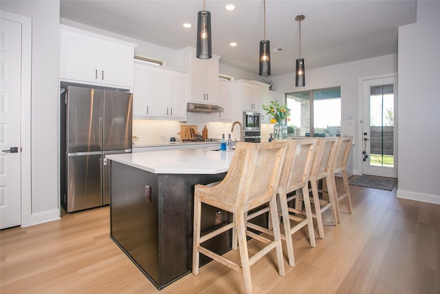 2708 Darlington Rd, Northlake, TX 76226 - kitchen featuring appliances with stainless steel finishes, light wood-style floors, a center island with sink, recessed lighting, and a breakfast bar area